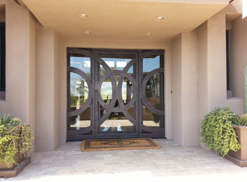 Photo of an expansive contemporary front door in Phoenix with beige walls, a double front door and a metal front door.