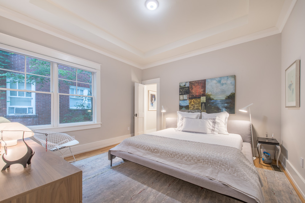 Design ideas for a transitional bedroom in Atlanta with grey walls, medium hardwood floors and brown floor.