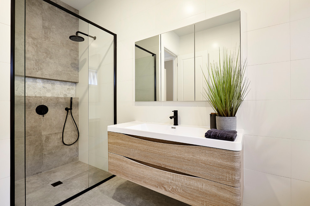 Inspiration for a beach style 3/4 bathroom in Melbourne with flat-panel cabinets, medium wood cabinets, an alcove shower, gray tile, cement tile, white walls, concrete floors, a console sink, grey floor and an open shower.