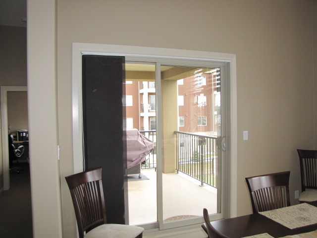 Example of a minimalist dining room design in Calgary