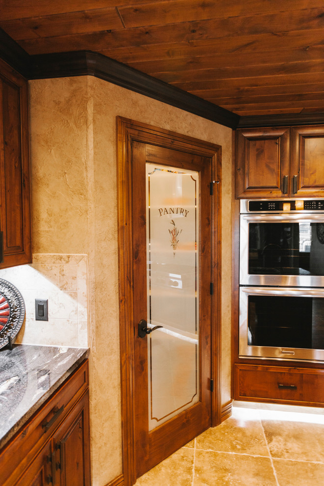 Kitchen - transitional kitchen idea with dark wood cabinets, quartz countertops, beige backsplash, custom tile backsplash, stainless steel appliances and beige walls