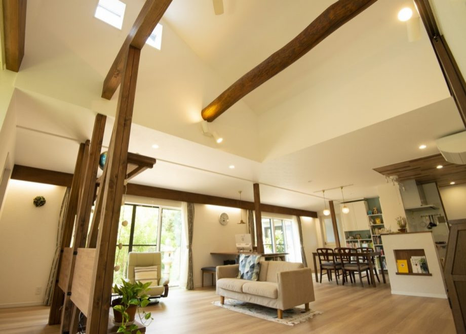 Landhausstil Wohnzimmer mit Sperrholzboden, braunem Boden, freigelegten Dachbalken und Tapetenwänden in Sonstige