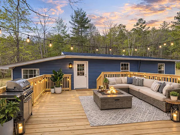 Newly constructed rear deck designed to expand the home's outdoor living space while complementing the updated exterior finishes.