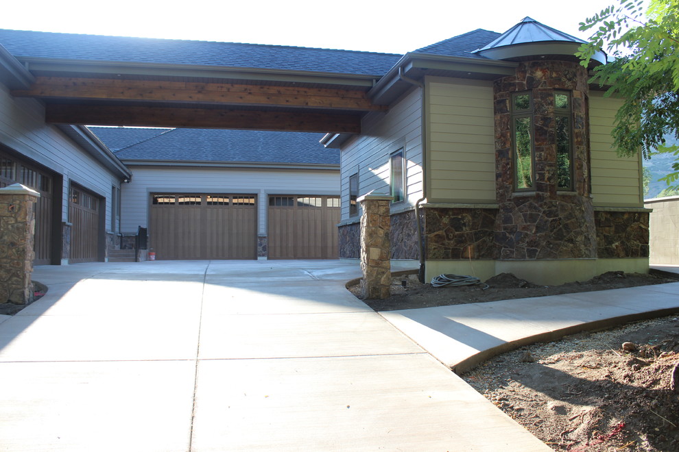 This is an example of a large traditional two-storey grey exterior in Salt Lake City with mixed siding.
