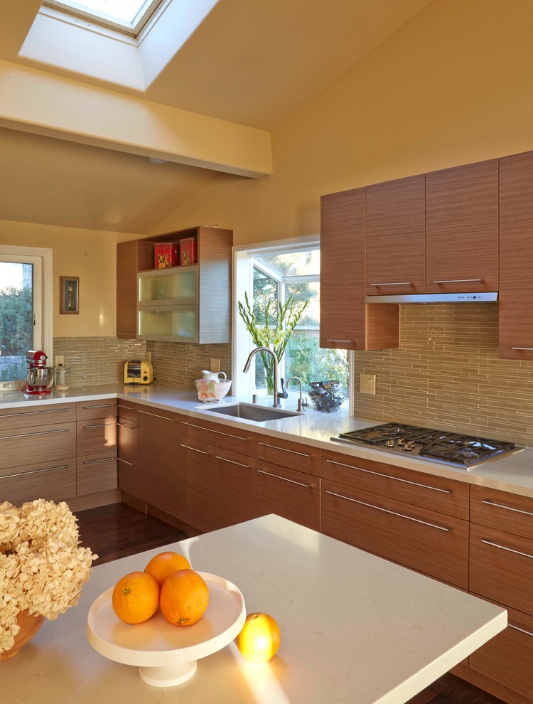 This is an example of a large contemporary u-shaped separate kitchen in San Francisco with an undermount sink, flat-panel cabinets, medium wood cabinets, quartz benchtops, green splashback, glass tile splashback, stainless steel appliances, dark hardwood floors and with island.