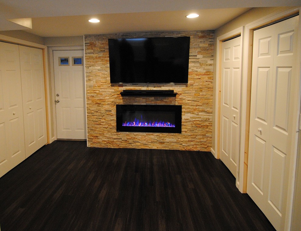 Design ideas for a mid-sized contemporary walk-out basement in New York with beige walls, vinyl floors and a stone fireplace surround.