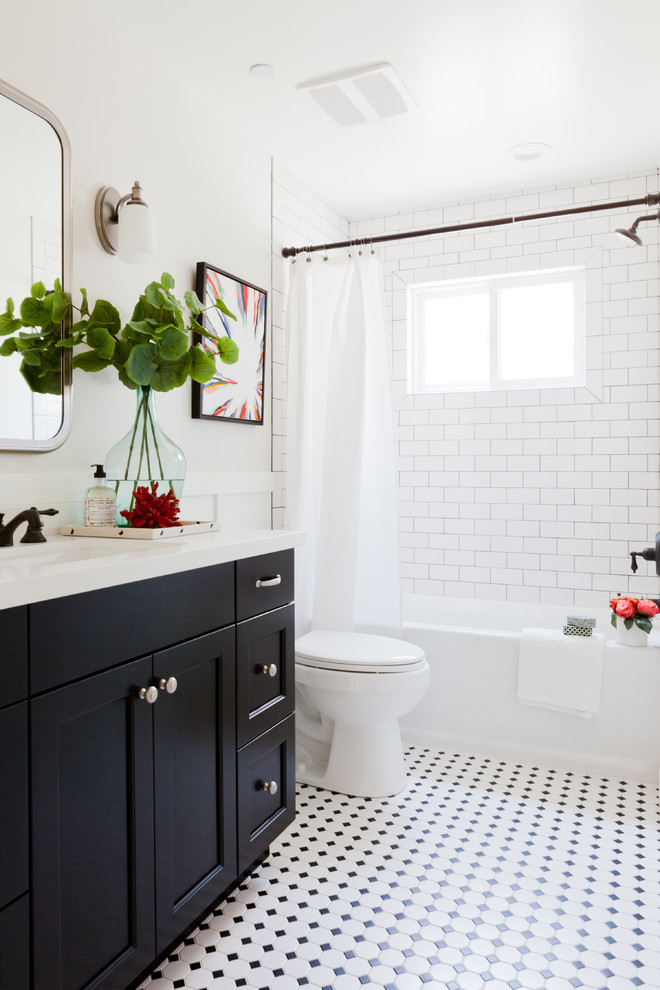 Design ideas for a beach style bathroom in Los Angeles with an undermount sink, black cabinets, an alcove tub, a shower/bathtub combo, a two-piece toilet, white tile, subway tile, mosaic tile floors, recessed-panel cabinets and multi-coloured floor.