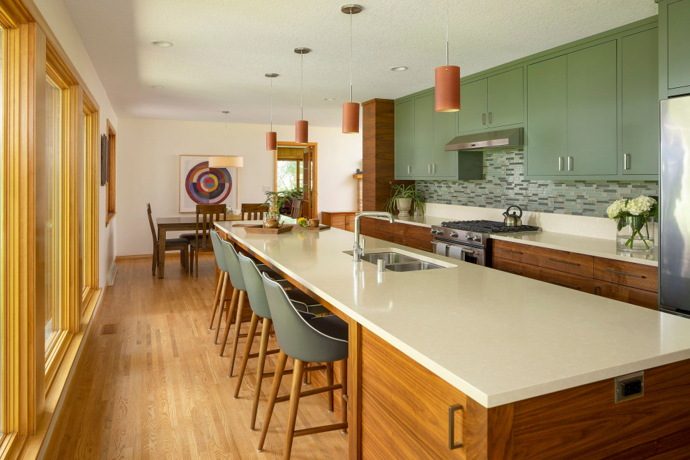 Design ideas for a large midcentury galley kitchen/diner in Other with a submerged sink, flat-panel cabinets, green cabinets, wood worktops, beige splashback, stainless steel appliances, light hardwood flooring, an island and beige worktops.
