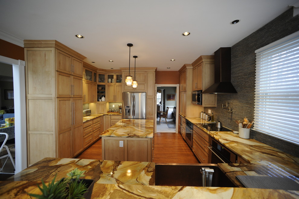 Inspiration for a mid-sized transitional u-shaped light wood floor eat-in kitchen remodel in Baltimore with a farmhouse sink, beaded inset cabinets, light wood cabinets, onyx countertops, stainless steel appliances and an island
