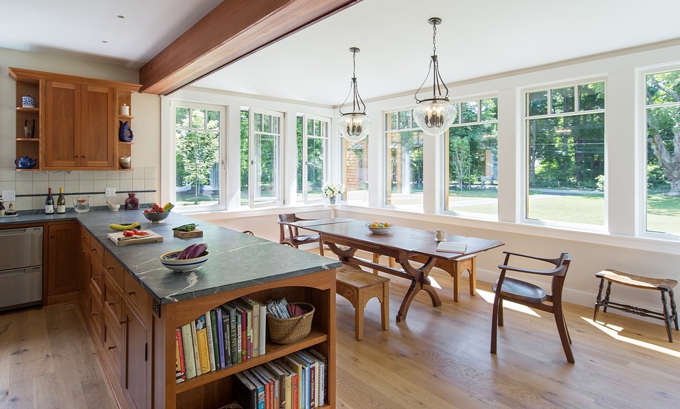 Example of a mid-sized farmhouse medium tone wood floor kitchen/dining room combo design in Boston with white walls