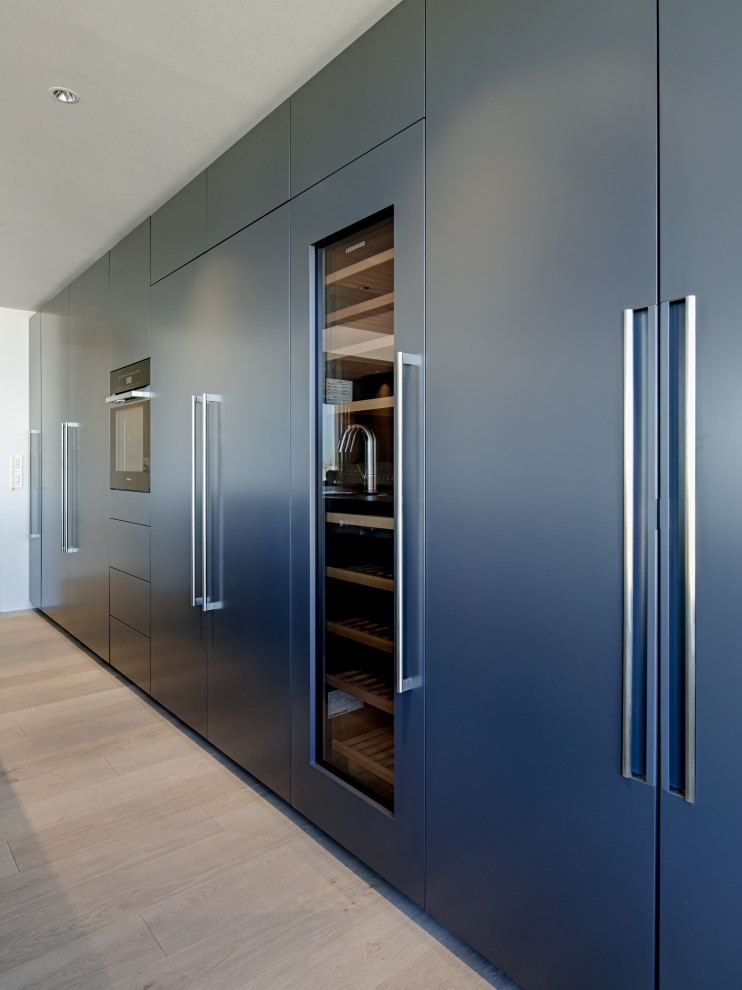 Design ideas for a modern galley open plan kitchen in Tokyo with grey cabinets, tile benchtops, with island and black benchtop.