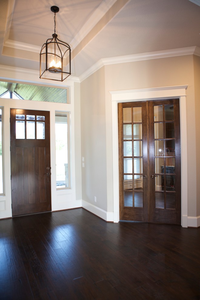 Inspiration for a mid-sized transitional dark wood floor and brown floor front door remodel in Houston with beige walls and a dark wood front door