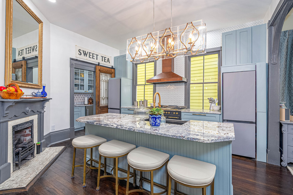 Large transitional galley dark wood floor and black floor eat-in kitchen photo with a single-bowl sink, shaker cabinets, blue cabinets, granite countertops, blue backsplash, ceramic backsplash, black appliances, an island and white countertops