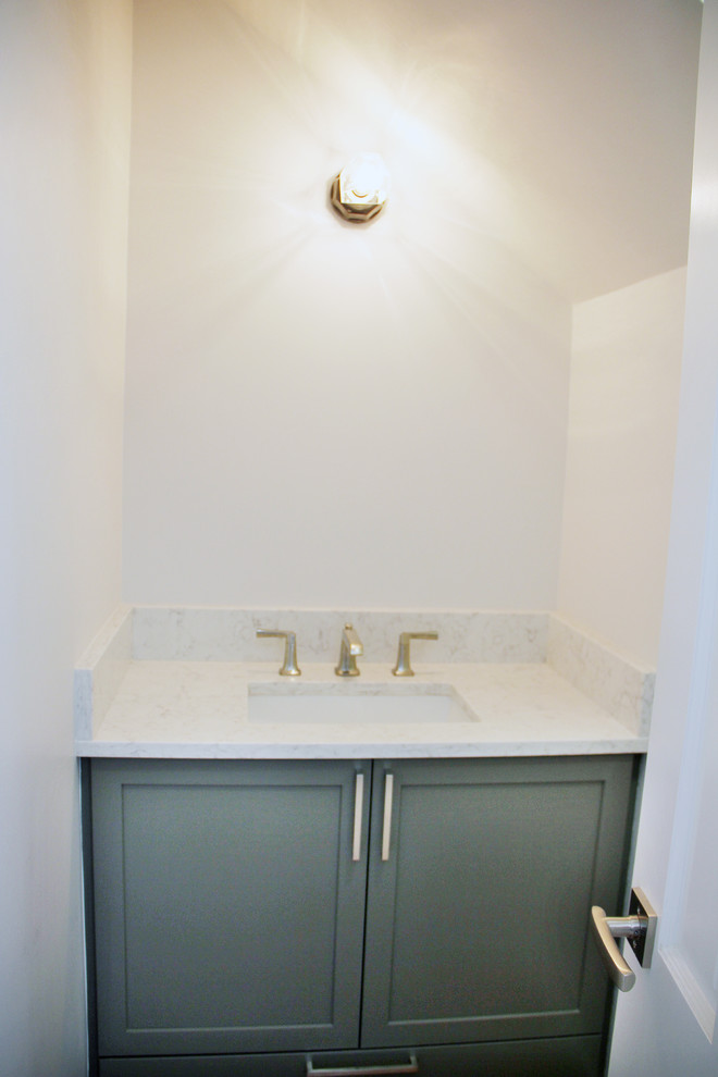 This is an example of a small modern powder room in Portland with shaker cabinets, green cabinets, white walls, an undermount sink and engineered quartz benchtops.