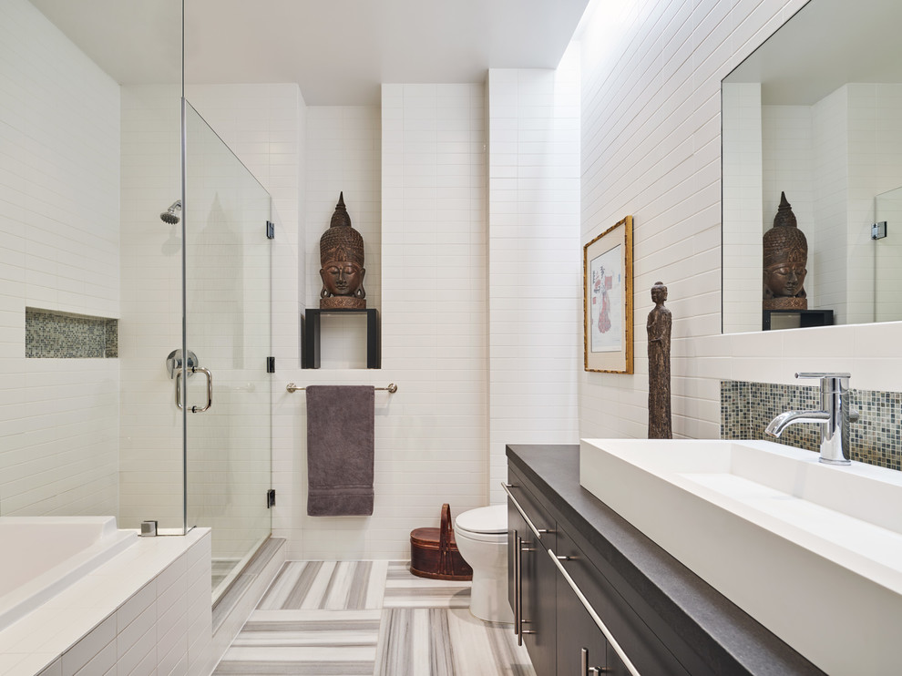 Asian master bathroom in New York with flat-panel cabinets, grey cabinets, a corner shower, white tile, white walls, a vessel sink, multi-coloured floor, a hinged shower door and grey benchtops.