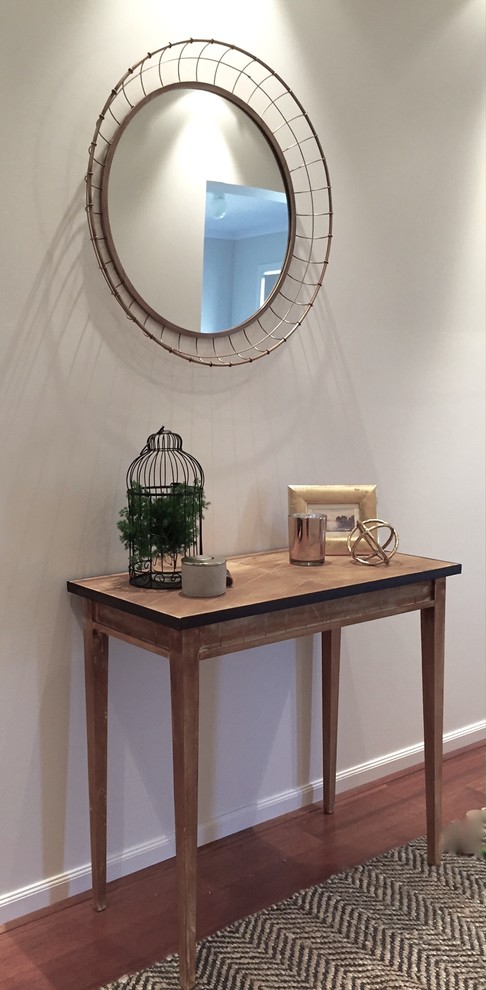 Inspiration for a small contemporary foyer in Melbourne with white walls, dark hardwood floors, a single front door and a medium wood front door.