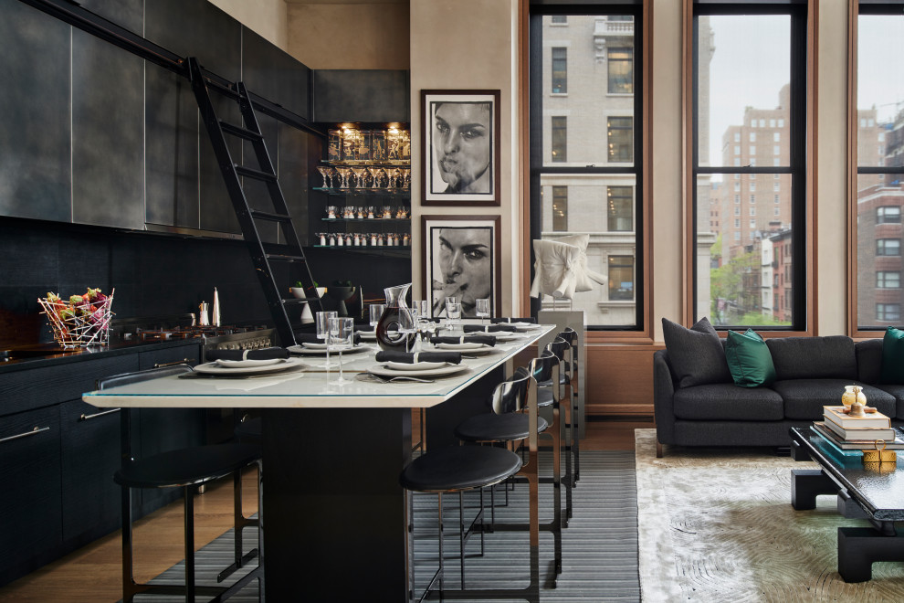 Inspiration for a small contemporary l-shaped eat-in kitchen in New York with an undermount sink, flat-panel cabinets, black cabinets, granite benchtops, black splashback, limestone splashback, panelled appliances, medium hardwood floors, no island, beige floor and black benchtop.