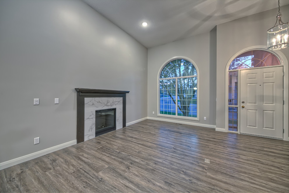 Inspiration for a contemporary family room in Calgary with grey walls, carpet and a tile fireplace surround.