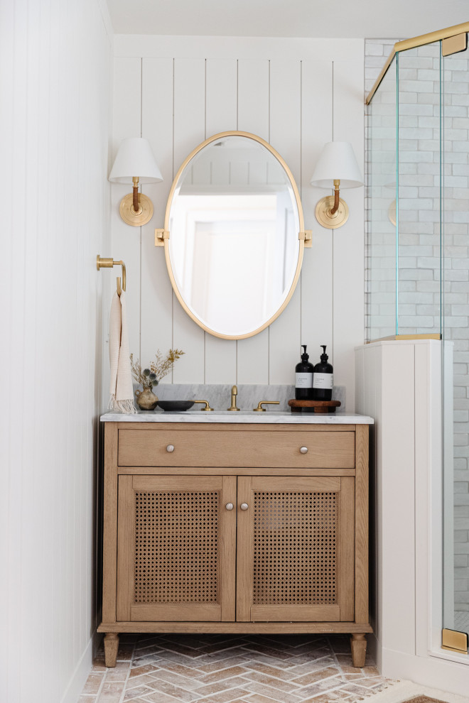 This is an example of a mid-sized transitional bathroom in Orlando with light wood cabinets, a corner shower, a two-piece toilet, white tile, terra-cotta tile, white walls, brick floors, marble benchtops, red floor, a hinged shower door, grey benchtops, a single vanity, a freestanding vanity and planked wall panelling.