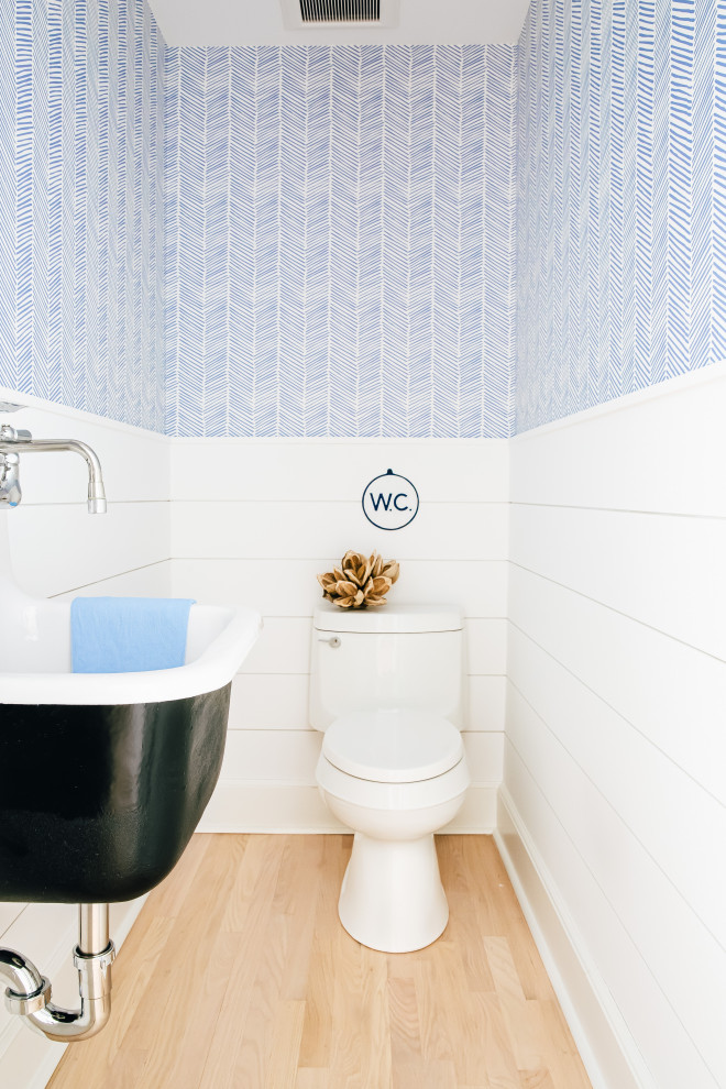 Design ideas for a large coastal cloakroom in Other with black cabinets, a one-piece toilet, white walls, light hardwood flooring, a wall-mounted sink, beige floors, a floating vanity unit, a wallpapered ceiling and tongue and groove walls.