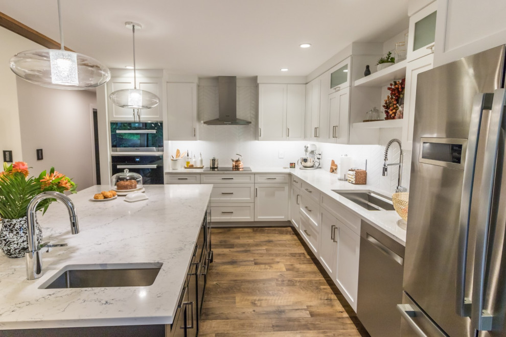 Example of a mid-sized l-shaped dark wood floor and brown floor kitchen design with a drop-in sink, recessed-panel cabinets, white cabinets, quartzite countertops, stainless steel appliances, an island and yellow countertops