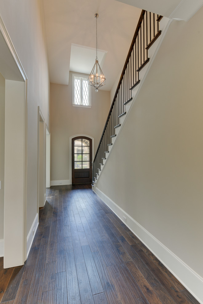 Inspiration for a large dark wood floor foyer remodel in Charlotte with gray walls and a dark wood front door