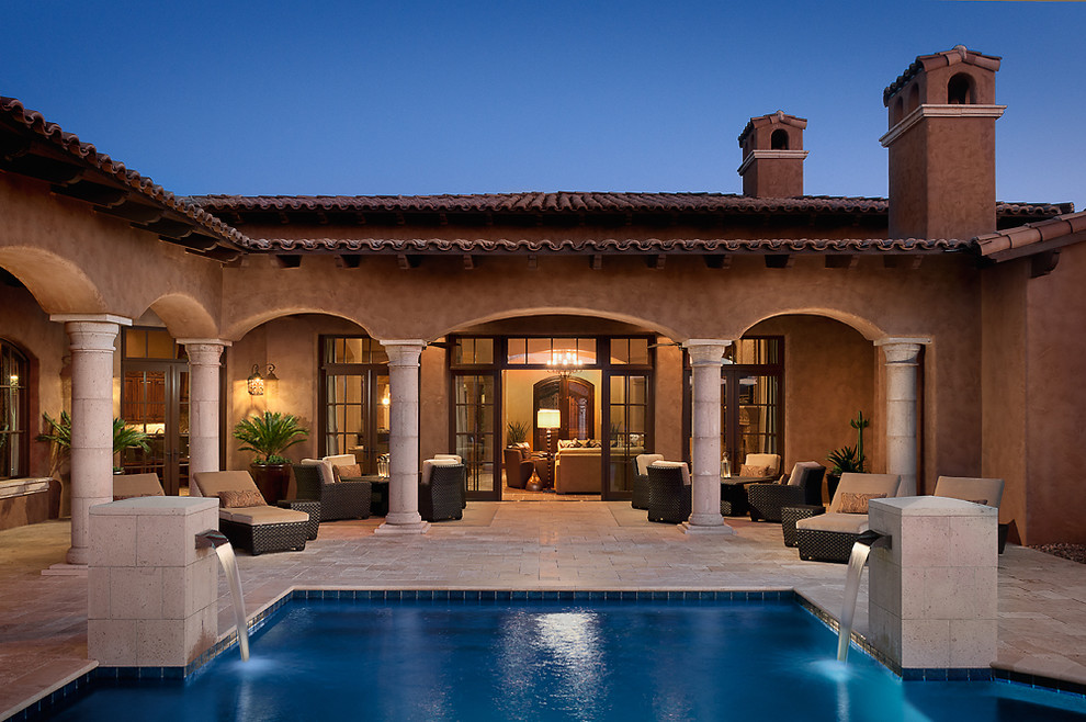 Mediterranean patio in Phoenix with a water feature.