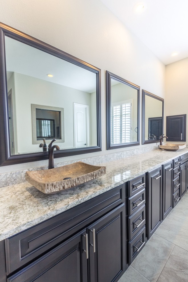 Inspiration for a large transitional master beige tile and ceramic tile ceramic tile home design remodel in Austin with flat-panel cabinets, brown cabinets, a one-piece toilet, beige walls, a vessel sink and granite countertops