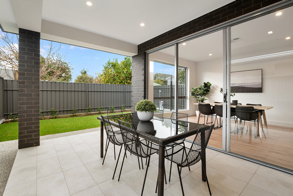Inspiration for a contemporary backyard patio in Adelaide with a roof extension.