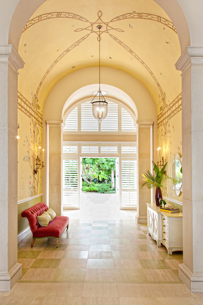Inspiration for a tropical entry hall in Miami with beige walls, painted wood floors and multi-coloured floor.
