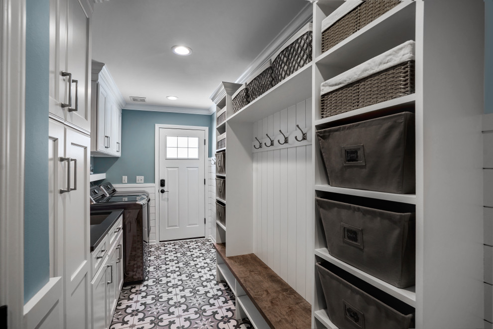 Inspiration for a mid-sized transitional galley utility room in Chicago with an undermount sink, recessed-panel cabinets, white cabinets, granite benchtops, blue walls, ceramic floors, a side-by-side washer and dryer, multi-coloured floor and black benchtop.