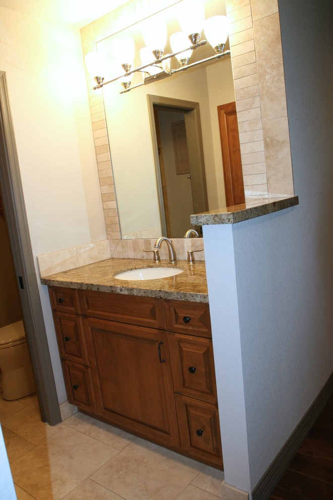 Inspiration for a mid-sized contemporary bathroom in Phoenix with an undermount sink, raised-panel cabinets, medium wood cabinets, granite benchtops, a double shower, beige tile, beige walls and travertine floors.