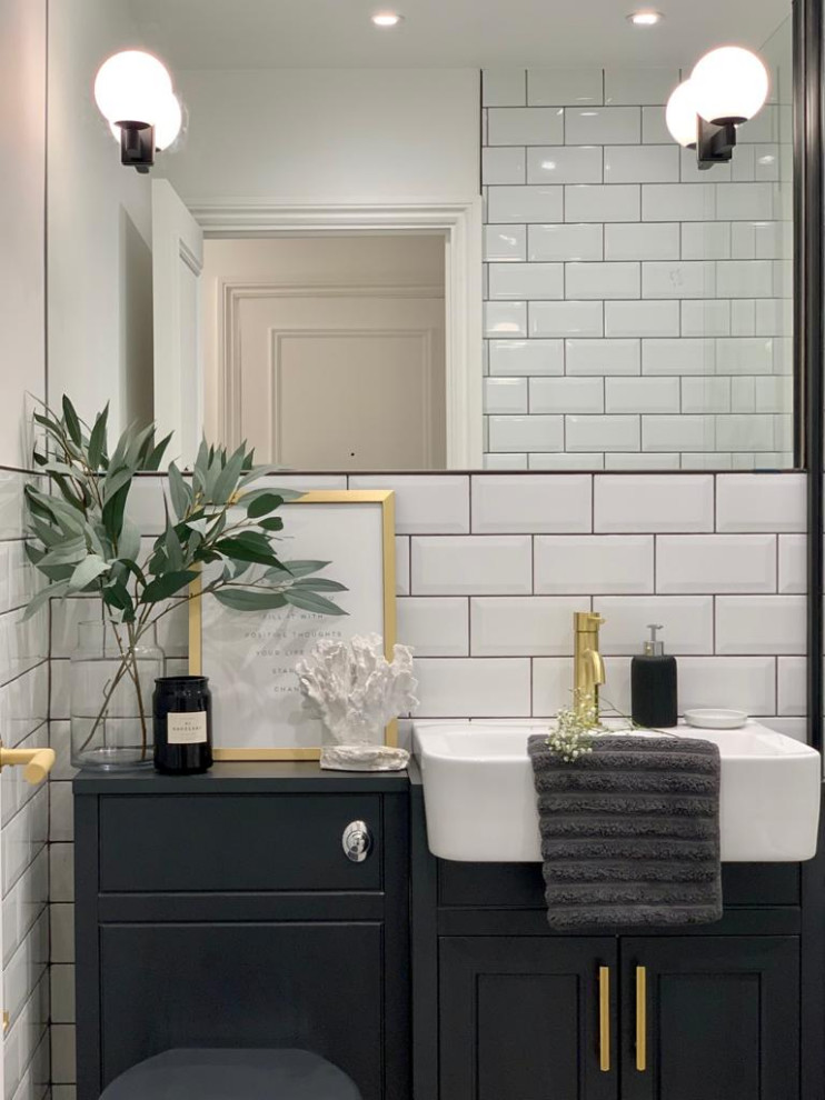 Photo of a mid-sized traditional kids bathroom in London with shaker cabinets, blue cabinets, a freestanding tub, a one-piece toilet, white tile, ceramic tile, white walls, porcelain floors, multi-coloured floor, a single vanity and a built-in vanity.