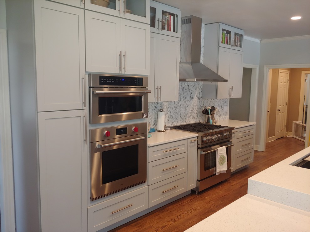 Inspiration for a large transitional single-wall light wood floor eat-in kitchen remodel with a single-bowl sink, shaker cabinets, gray cabinets, quartzite countertops, multicolored backsplash, stainless steel appliances, an island, white countertops and mosaic tile backsplash