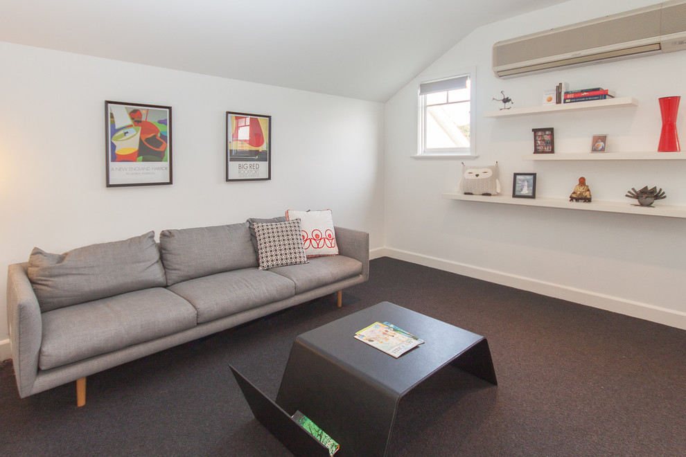 Mid-sized contemporary loft-style living room in Melbourne with white walls and carpet.
