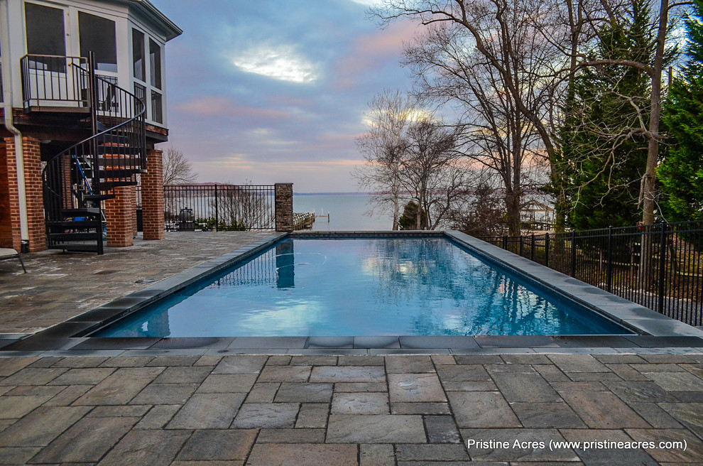 Pool - huge transitional backyard concrete paver and rectangular lap pool idea in DC Metro
