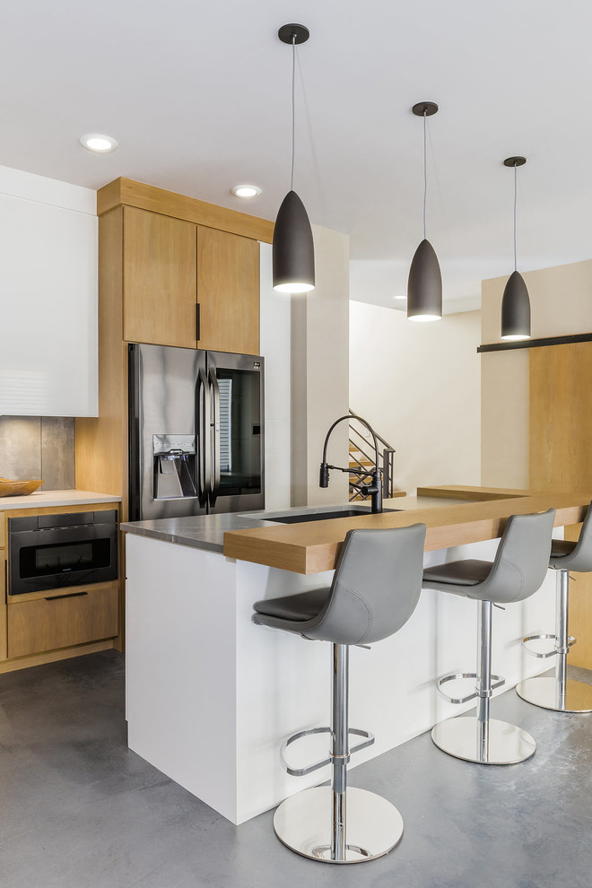 Design ideas for a contemporary kitchen in Other with an undermount sink, flat-panel cabinets, light wood cabinets, grey splashback, stainless steel appliances, concrete floors, with island and grey floor.