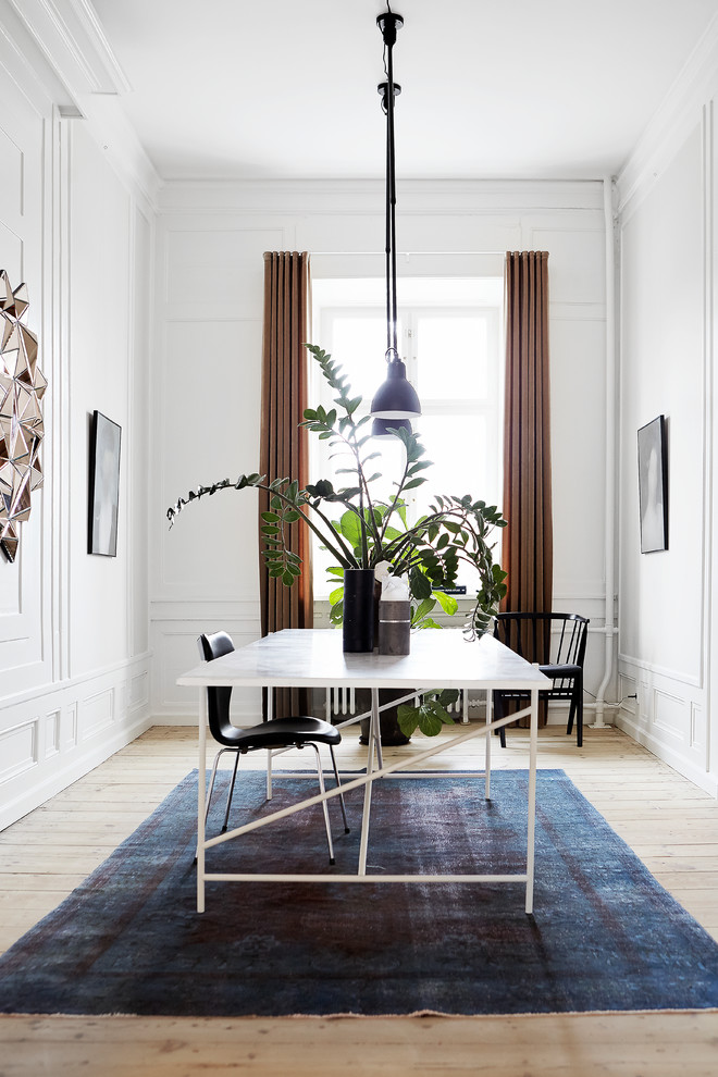 Inspiration for a mid-sized transitional separate dining room in Aarhus with white walls, light hardwood floors and beige floor.