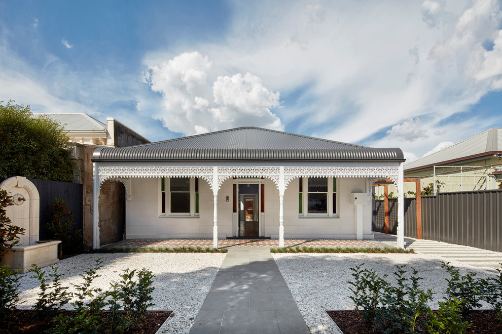 Design ideas for a mid-sized traditional one-storey stucco white exterior in Melbourne with a hip roof.