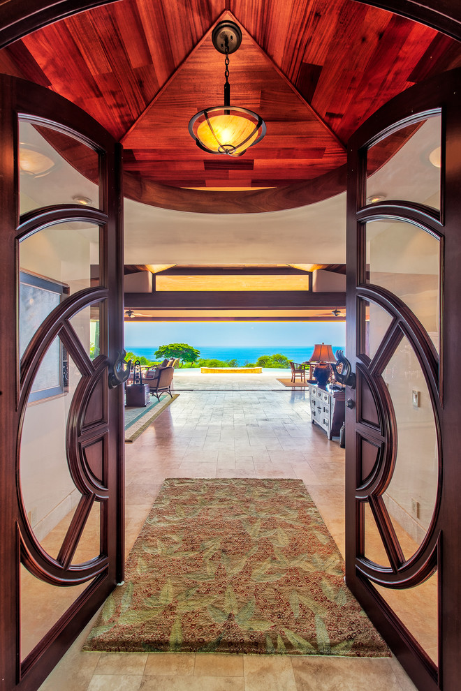 Inspiration for an expansive tropical front door in Hawaii with beige walls, travertine floors, a double front door and a medium wood front door.