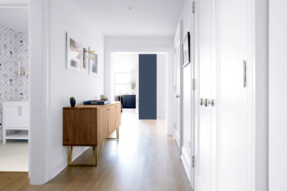 Design ideas for a mid-sized contemporary hallway in San Francisco with white walls and medium hardwood floors.