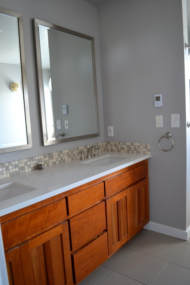 Mid-sized transitional bathroom in Seattle with an undermount sink, shaker cabinets, medium wood cabinets, engineered quartz benchtops, beige tile, ceramic tile, grey walls and ceramic floors.