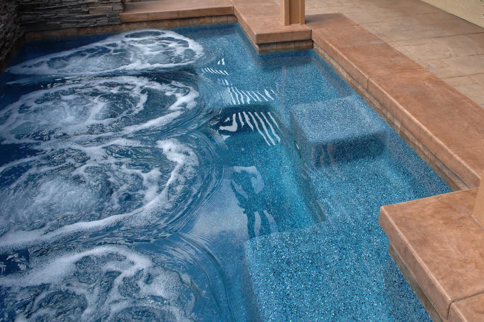 Hot tub - mid-sized transitional backyard concrete paver and custom-shaped lap hot tub idea in Orange County