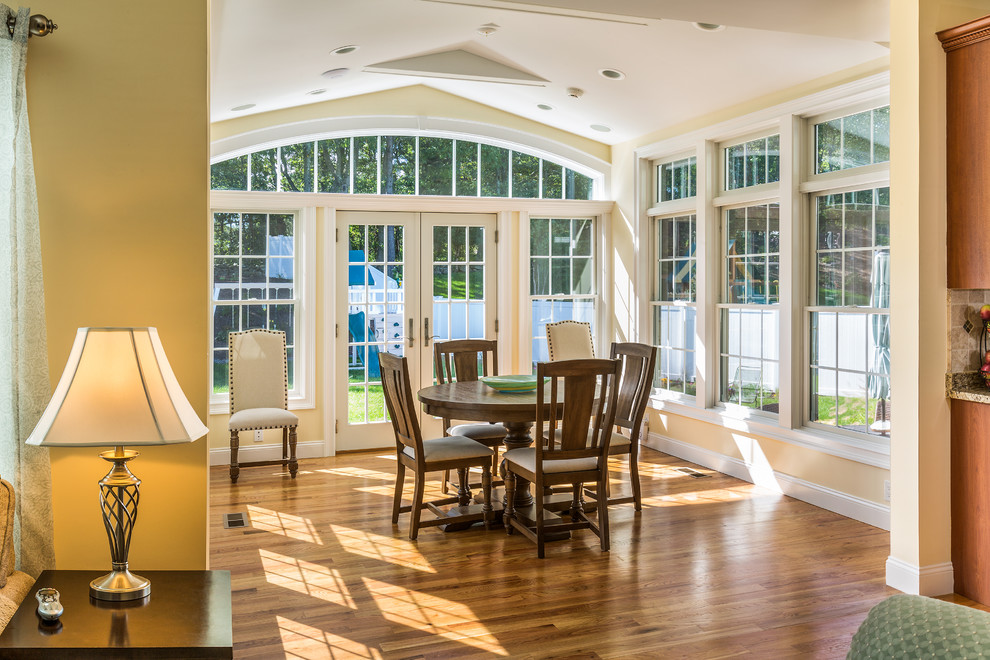 Inspiration for a mid-sized traditional sunroom with marble floors, no fireplace, a standard ceiling and brown floor.