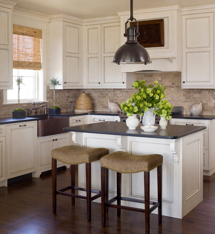 Design ideas for a large traditional l-shaped kitchen in Raleigh with a farmhouse sink, beaded inset cabinets, white cabinets, onyx benchtops, multi-coloured splashback, dark hardwood floors and with island.