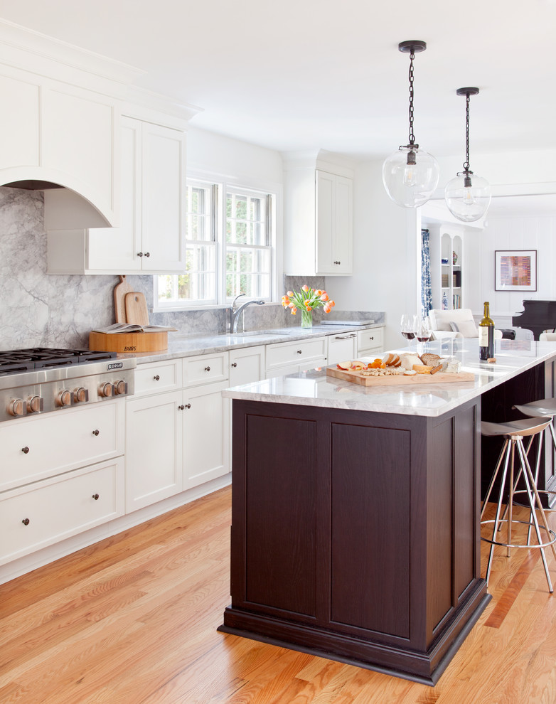 Inspiration for a traditional l-shaped kitchen in Richmond with an undermount sink, recessed-panel cabinets, white cabinets, grey splashback, stainless steel appliances, medium hardwood floors, with island, brown floor and grey benchtop.