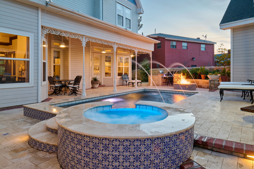 Traditional backyard rectangular pool in Other with a hot tub and natural stone pavers.