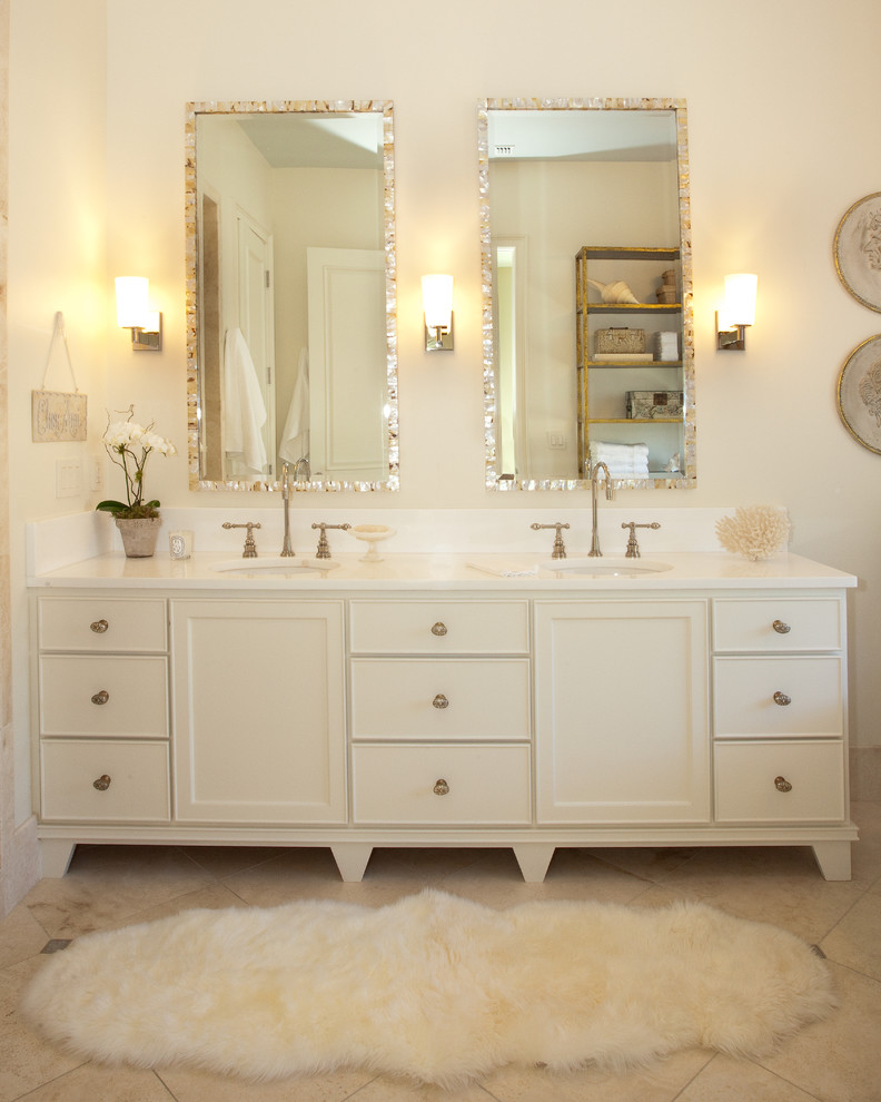 Design ideas for a transitional master bathroom in Sacramento with furniture-like cabinets, white cabinets, a freestanding tub, white walls, limestone floors, an undermount sink and marble benchtops.