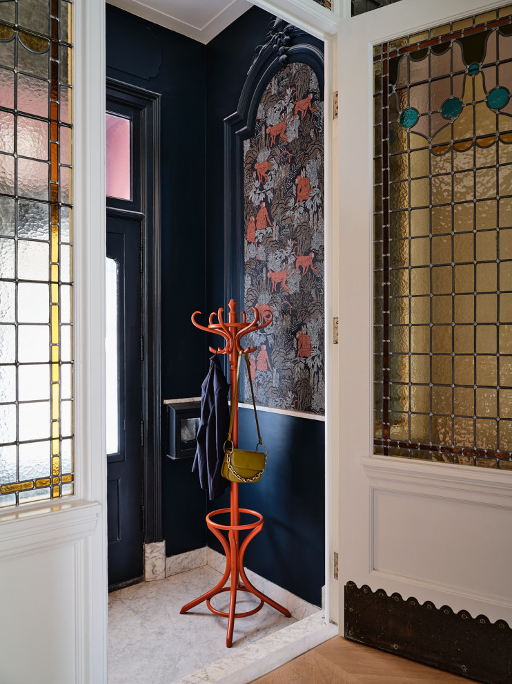 Eclectic white floor vestibule photo in Amsterdam with blue walls and a glass front door