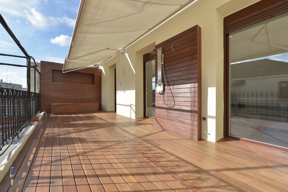 Contemporary deck in Other with an outdoor shower and an awning.